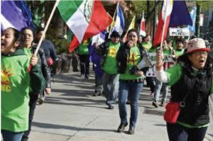 Activist junior Dalia Mena (above with megaphone) and sophomore Brian Geans organized students to join a city-wide protest on May 15 to fight for fair wages for workers. Photo by Emily Santiago.